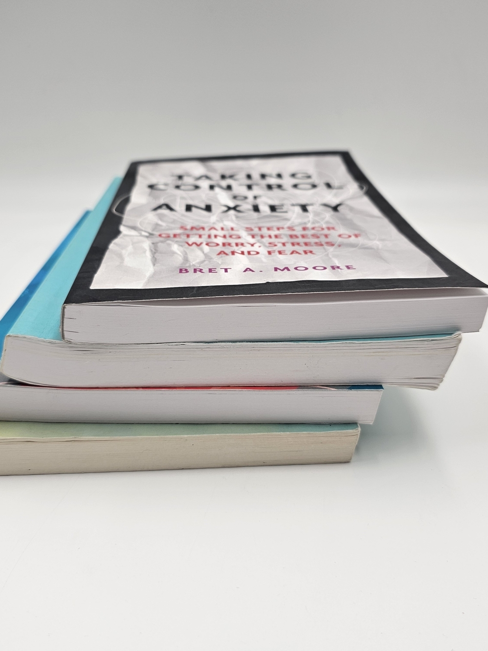 Stack of Mindfulness & CBT Books in Black, Teal, Blue, and Cream - Picture 2 of 14